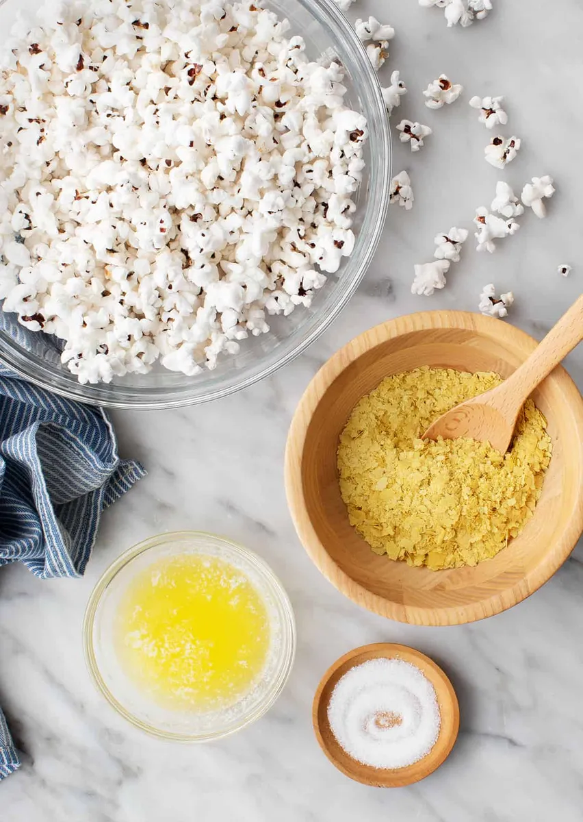 Popcorn with butter, sea salt, and savory seasoning arranged as ingredients